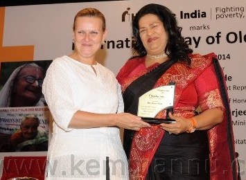 Excellence Award being conferred upon Madam Grace Pinto.