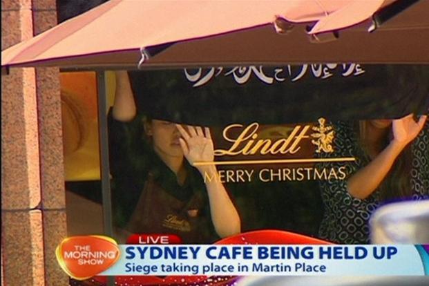 Hostages held in Sydney cafe, forced to hold Islamic flag in window