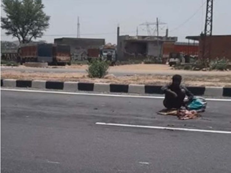 Shocking video of a hungry man eating a dead dog’s carcass on the road sparks outrage