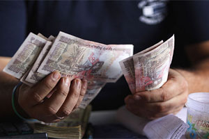 Indian rupee gains 158 paise to 61.80 against dollar on Fed’s surprise decision